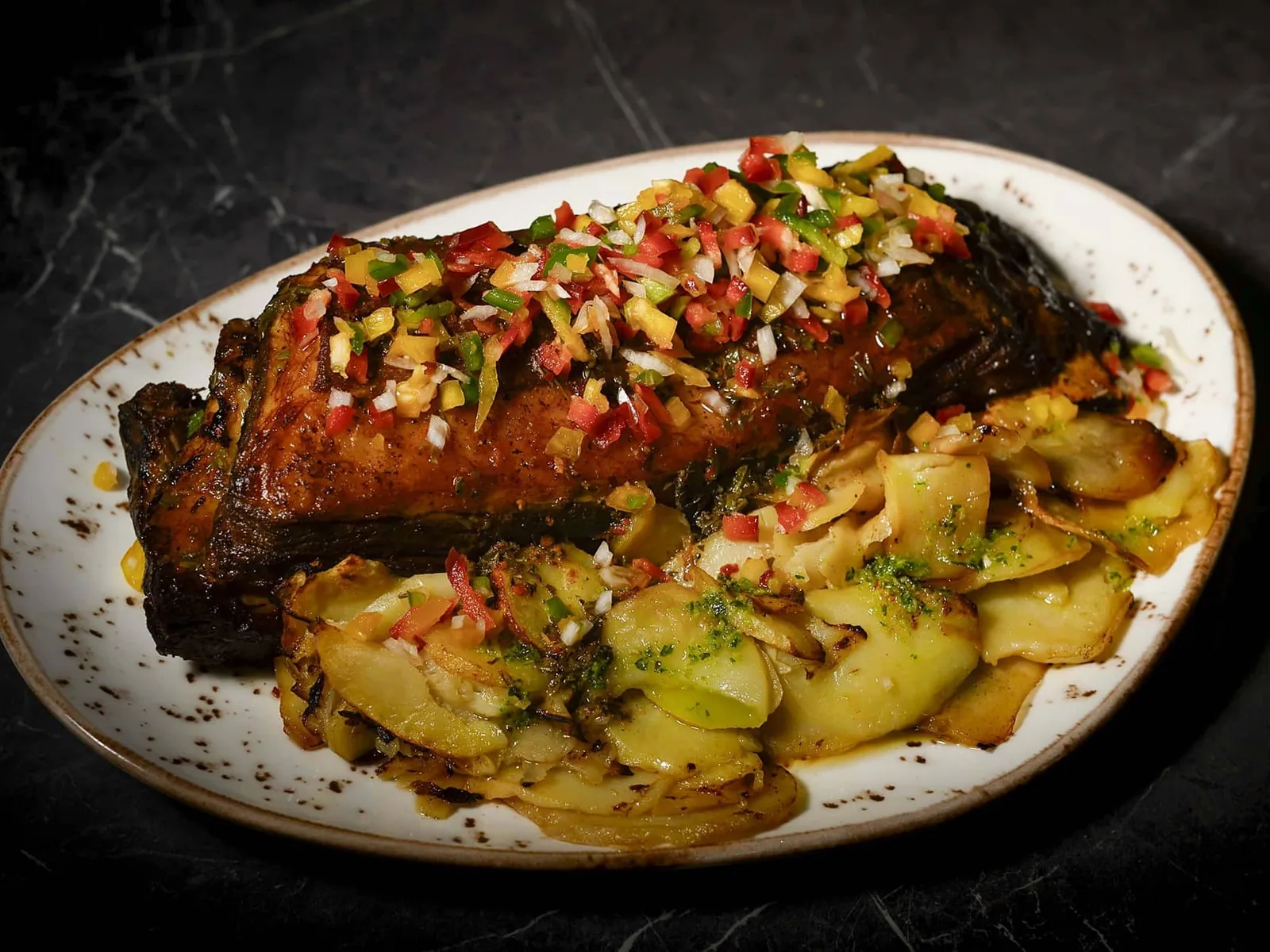 Costillar de Angus argentino asado a baja temperatura con chimichurri y patata confitada